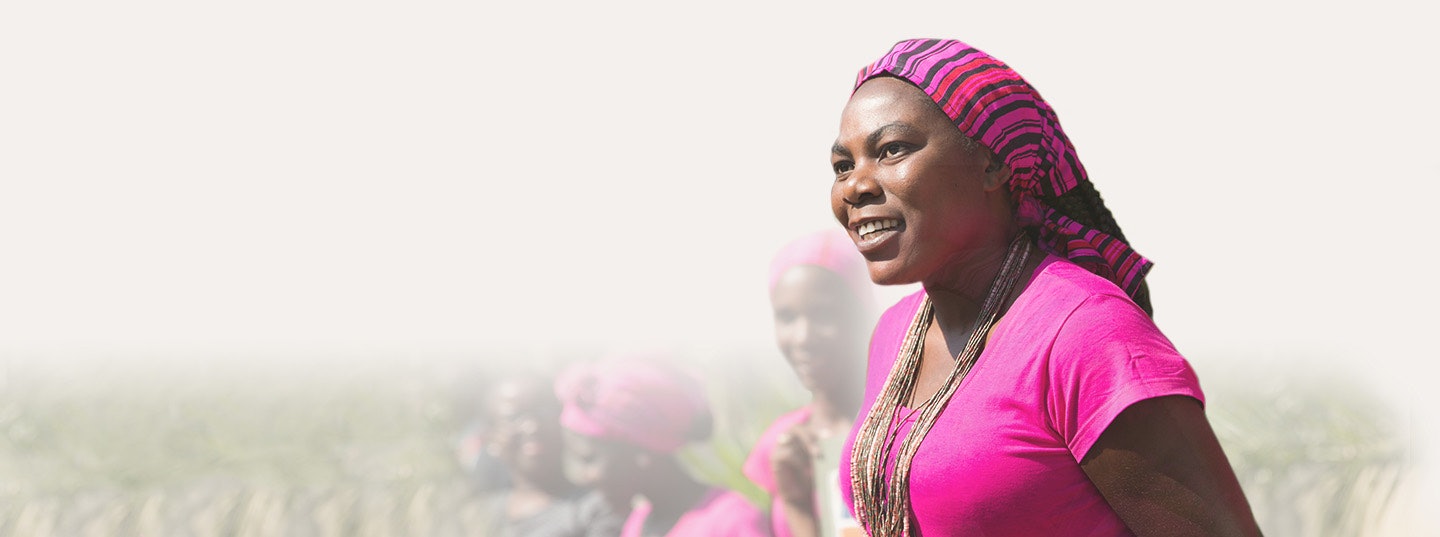 Female in Africa standing in a field.