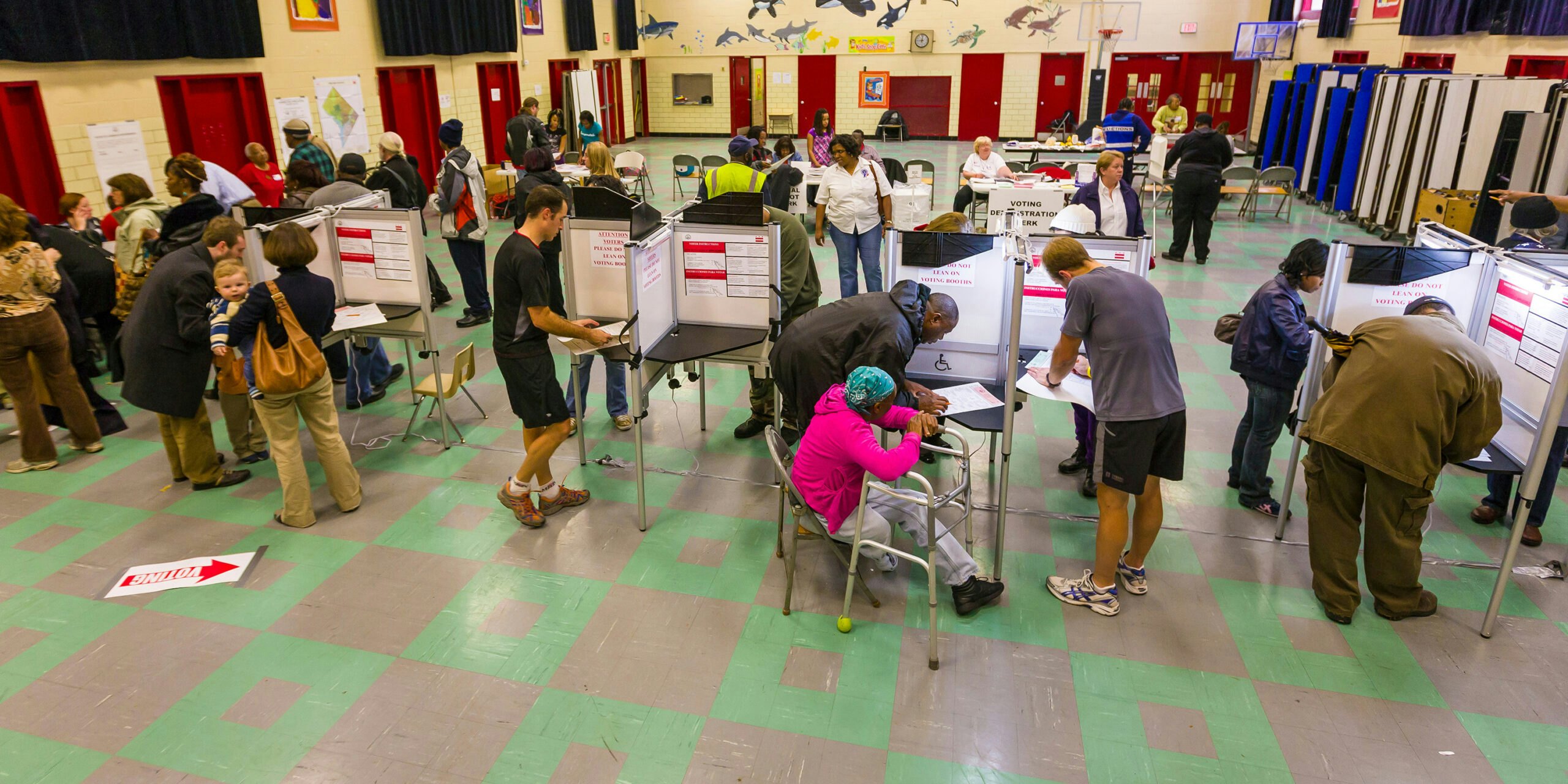 Group of people in a gym voting.